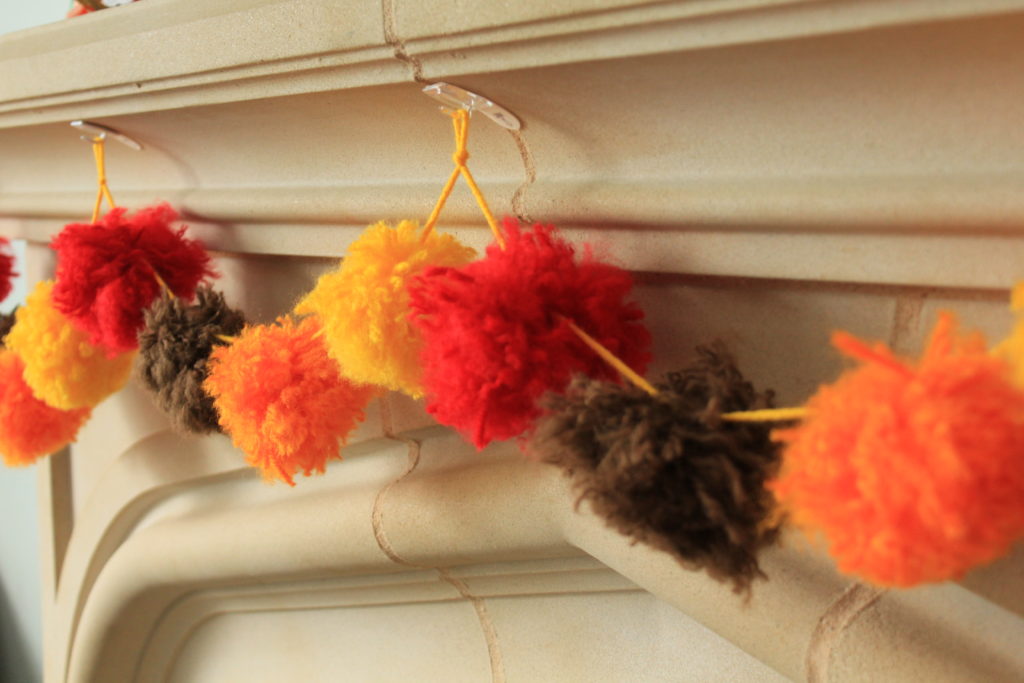 How to make your own DIY pom pom garland decoration out of yarn.  Simple and easy to do!