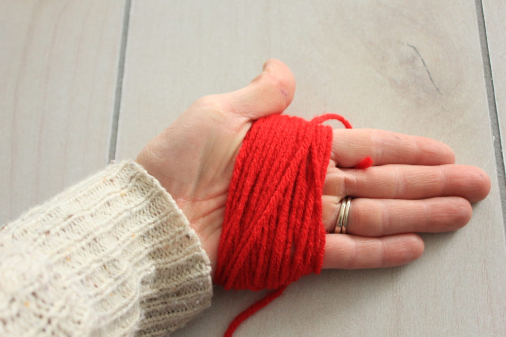 How to make your own easy DIY pom pom garland decoration out of yarn.  Simple and easy to do!