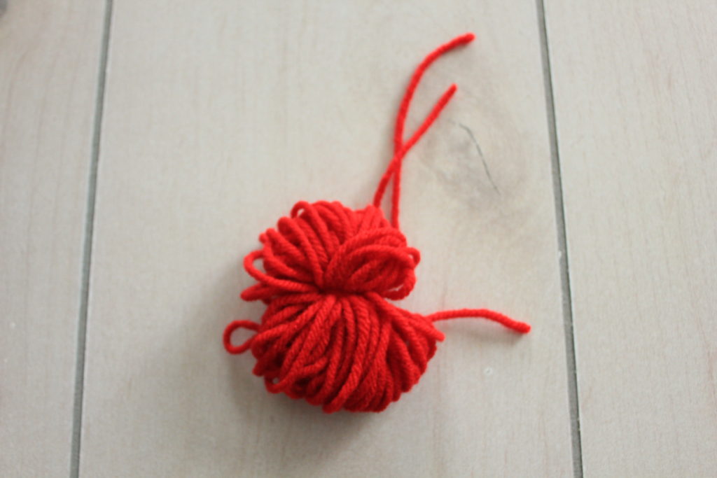 How to make your own easy DIY pom pom garland decoration out of yarn.  Simple and easy to do!