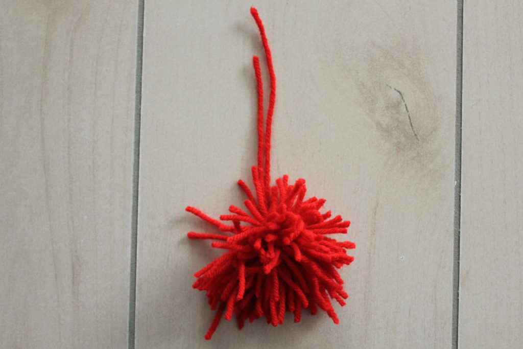 How to make your own easy DIY pom pom garland decoration out of yarn.  Simple and easy to do!