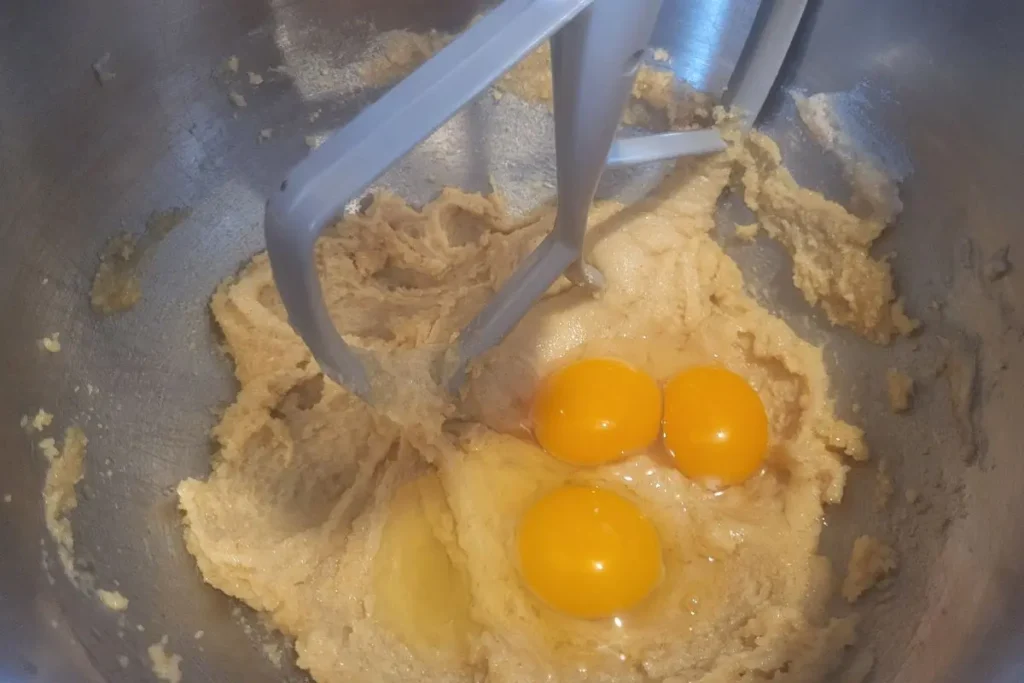 adding eggs to cookie dough with fresh milled flour