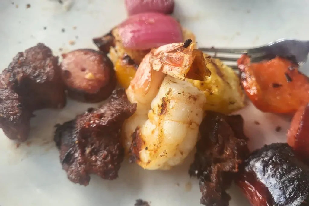 grilled steak and shrimp kabobs on plate
