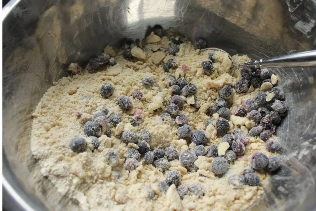 adding blueberries to dry ingredients